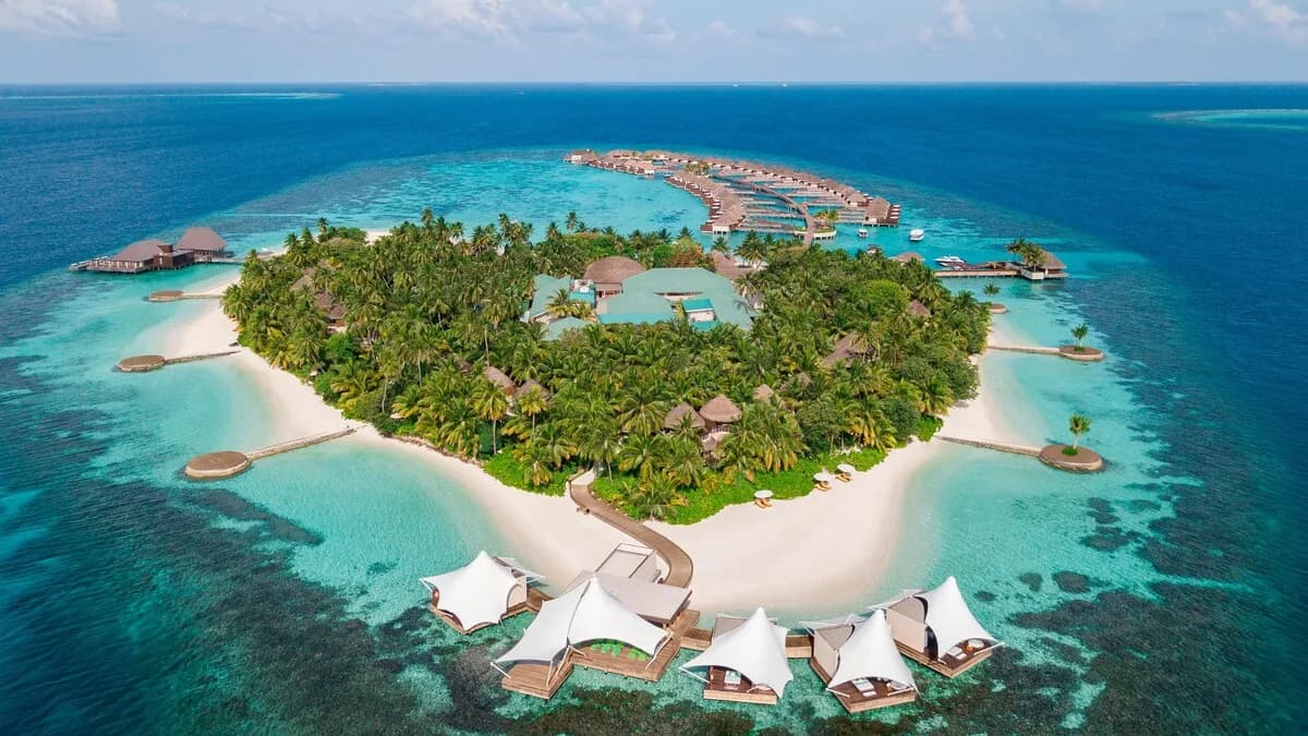 W Maldives island resort and overwater villas surrounded by a turquoise lagoon