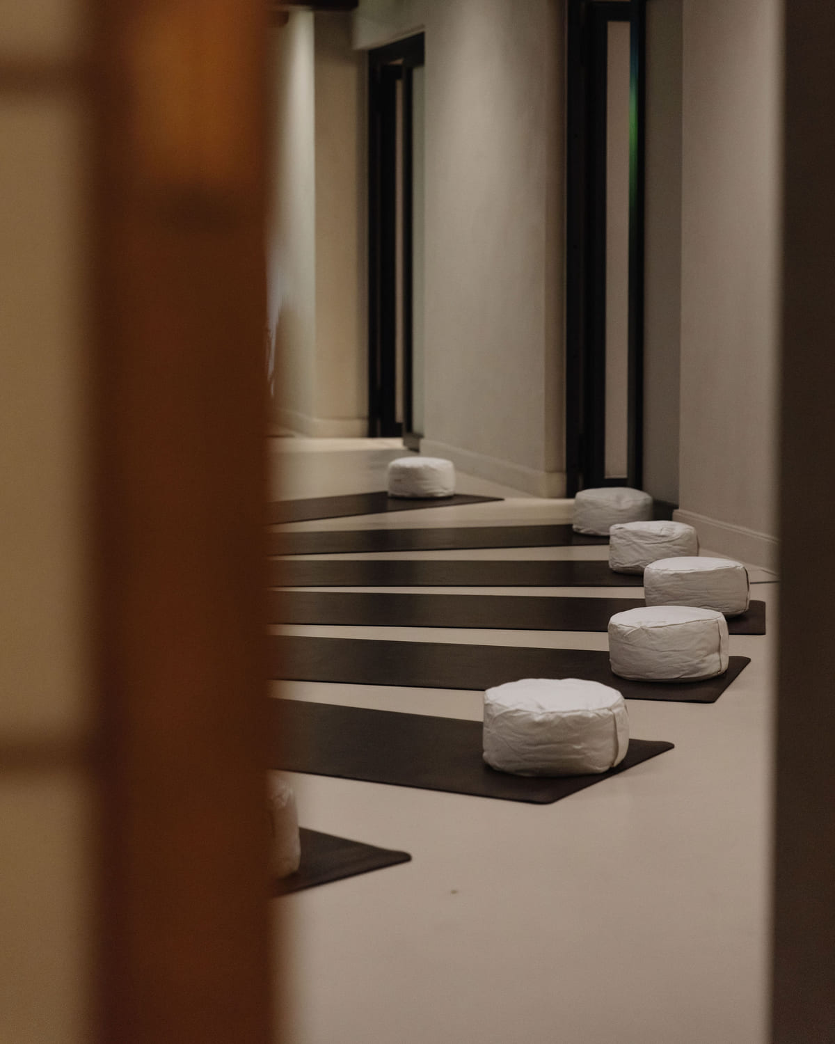 Floor cushions set out on tiered steps before a session begins