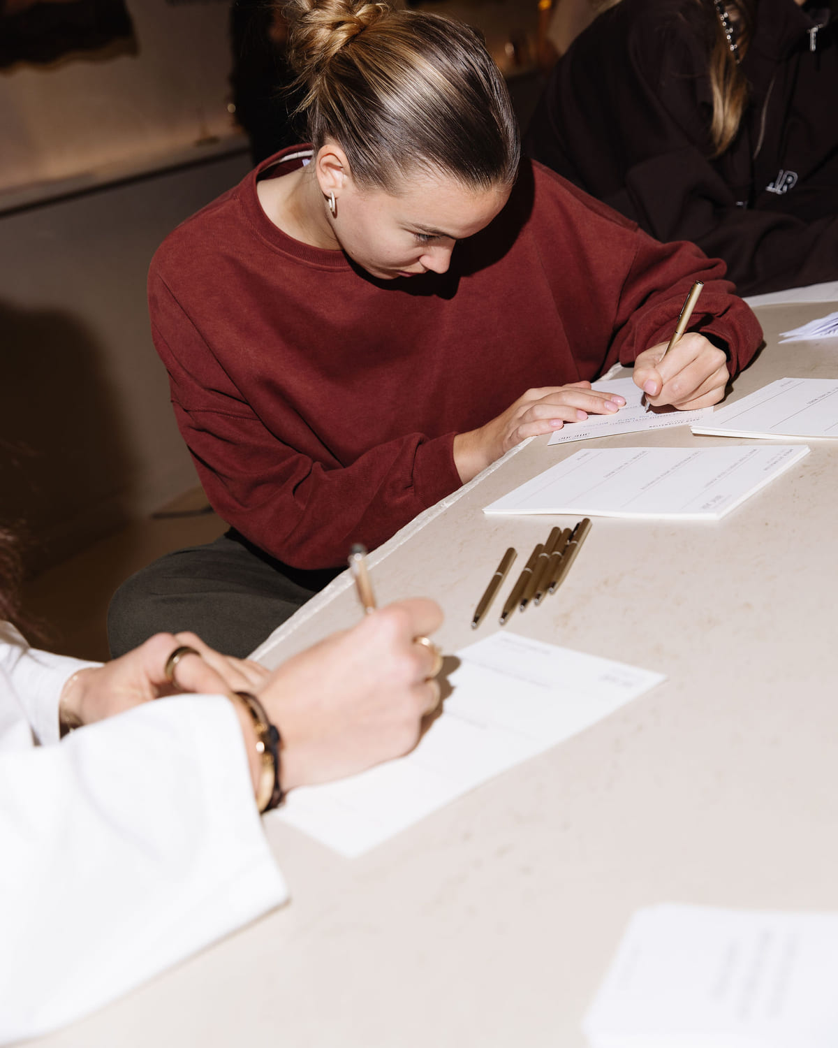 An attendee taking notes during a workshop exercise